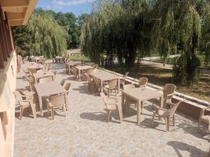 a row of tables and chairs on a patio at For Fun resort naturist libertin - adults only in Costinesti