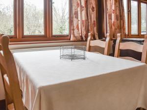a white table with a basket on top of it at Uk46715 - The Coach House in Plumstead