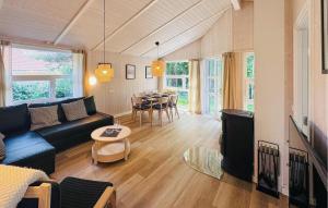 a living room with a couch and a table at Morgensonne 4 - Dorf 2 in Priwall