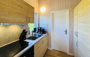 a kitchen with a sink and a counter top at Morgensonne 4 - Dorf 2 in Priwall