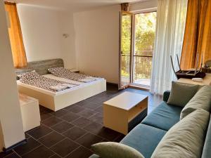 a living room with a couch and a bed at Limani Guest house in Sozopol +55 photos