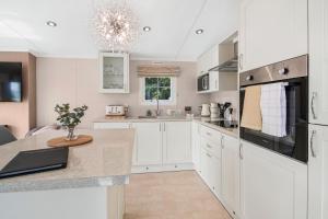 a kitchen with white cabinets and a counter top at European Lodge - Uk40848 in Scarborough