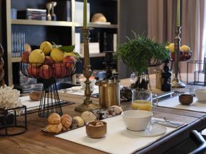 a table with a bowl of fruit and other foods at San Domenico in Ravenna