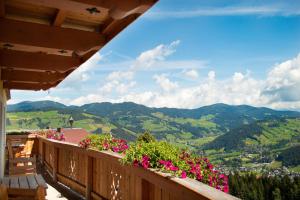 a balcony with flowers and a view of the mountains at Ferienwohnungen Krapfenalm in Wagrain