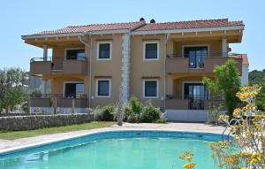 a villa with a swimming pool in front of a house at Eight-Bedroom Holiday Home In Pasman in Pašman