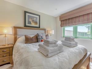 a bedroom with a white bed with towels on it at Mayflower - Uk43632 in Grange