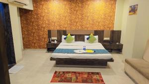 a bedroom with a bed in a room at Hotel Krishna in Nagpur