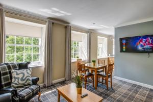 a living room with a couch and a table at New Lanark Self Catering Waterhouses in Lanark