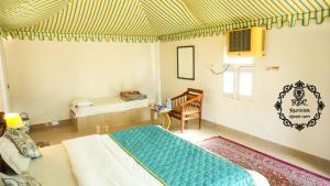 A bed or beds in a room at Rajputana Desert Camp