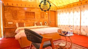 A bed or beds in a room at Rajputana Desert Camp