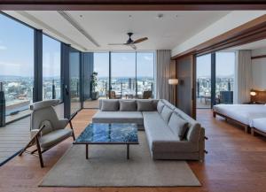 a living room with a couch and a bed at One Fukuoka Hotel in Fukuoka