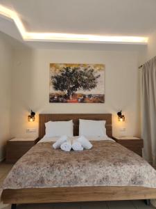 a bedroom with a large bed with two pillows at Vassiliki Studios in Andros