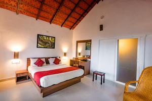 a bedroom with a large bed and a window at After the Rains - Rainforest Lodge in Meppādi +24 photos