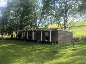 a tiny house in a field with a yard at The Pastures Eston Farm Stay in Mid Illovo