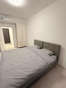 a bedroom with a large bed in a white room at EasyStay by Fuat in Struga