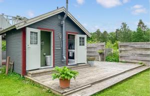 a tiny house on a wooden deck in a yard at 1 Bedroom Gorgeous Home In Romakloster in Romakloster +9 photos