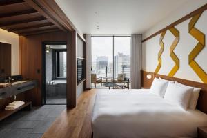 a hotel room with a large bed and a bathroom at One Fukuoka Hotel in Fukuoka +103 photos