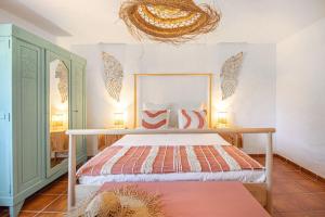 a bedroom with a bed and a chandelier at Alma Alentejo Villa in Bicos