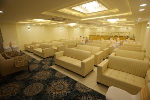 a room with couches and chairs in a waiting room at Hotel Neo in Jaipur