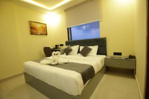 a bedroom with a bed with a towel on it at Hotel Neo in Jaipur