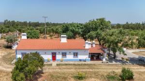 a small white house with a red roof at Alma Alentejo Villa in Bicos