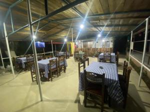 a dining room with tables and chairs and lights at Bunec Seascape Villa Apartments in Piqeras