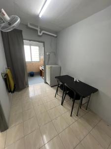 a dining room with a table and a refrigerator at Al - Nimah homestay in Simpang Ampat