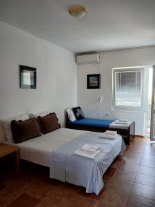a room with a bed and a couch in it at vila Rosmarin in Dobra Voda