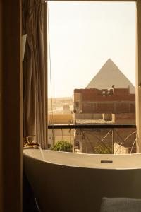 a view of the pyramids from a window in a room at Jimmy Pyramids Hotel in Cairo +98 photos