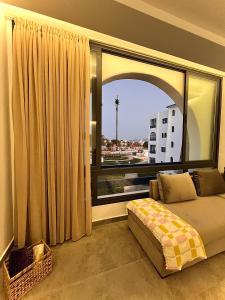 a bedroom with a bed and a large window at Luxury apartment near golf beach in Cabo Negro