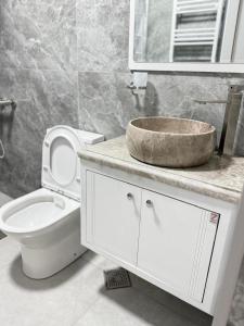 a bathroom with a white toilet and a sink at Mariami in Kobuleti +55 photos