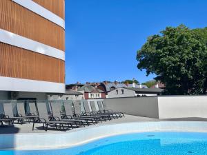 a swimming pool on the roof of a building at Baltic Waves Resort & SPA Międzyzdroje 3 in Międzyzdroje +47 photos