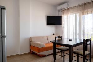a living room with a table and a couch at Horizon Villa Ksamil in Ksamil