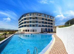 a hotel with a swimming pool in front of a building at Cabo Dream 71 in Cabo Negro