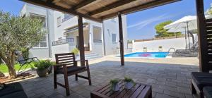 a patio with a chair and a swimming pool at Apartment Alicia with private pool in Vodice +47 photos