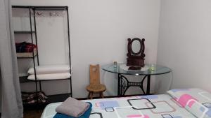 a bedroom with a bed and a table with a mirror at Apartamento Tita in Canosio