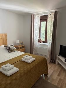 a bedroom with a bed with two towels on it at Domaine du Haut-Koenigsbourg in Orschwiller +26 photos