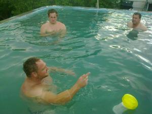 a group of men in a swimming pool with a frisbee at Ons Huisie - No Loadshedding in Beaufort West