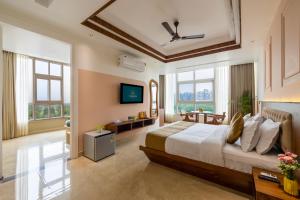 a bedroom with a large bed and a television at Yashobhoomi Stay near Delhi Airport by PMH in New Delhi
