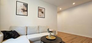 a living room with a couch and a table at BYTOM One 24H Strefa Komfortu in Bytom +17 photos