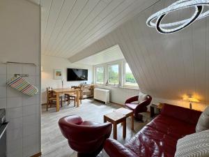 a living room with a couch and a dining room at Ferienwohnung in Tinnum auf Syt in Tinnum