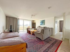 a bedroom with a bed and a couch and a table at Dreizimmerwhg im Zentrum Westerland, Hanseatenhaus App 34 Balkon und Garage in Westerland (Sylt)