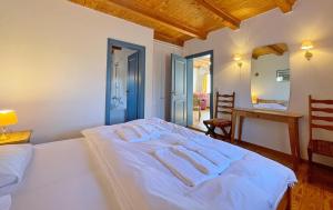 a bedroom with a white bed with towels on it at Haus-Wolfram-App-Wilhelmine in Morsum