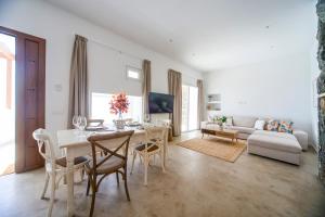 a living room with a table and chairs and a couch at Luxury House La Maison II in Tías