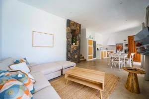 a living room with a white couch and a table at Luxury House La Maison II in Tías