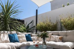 a white couch with pillows on a patio at Arz - 2 pièces neuf proche gare de Vannes in Vannes