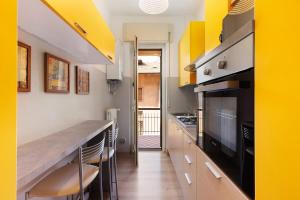 a kitchen with yellow walls and a counter top at Bergamo Centre - 5min from BGY Airport, WiFi, AC in Bergamo