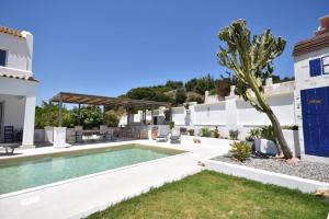 a villa with a swimming pool and a house at Sofia Villa Near Faliraki in Kalithies