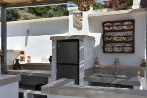 a outdoor kitchen with a sink and a sink at Sofia Villa Near Faliraki in Kalithies
