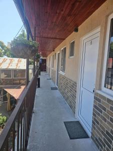 a porch with a white door on a building at casa la meduza in Vama Veche +30 photos